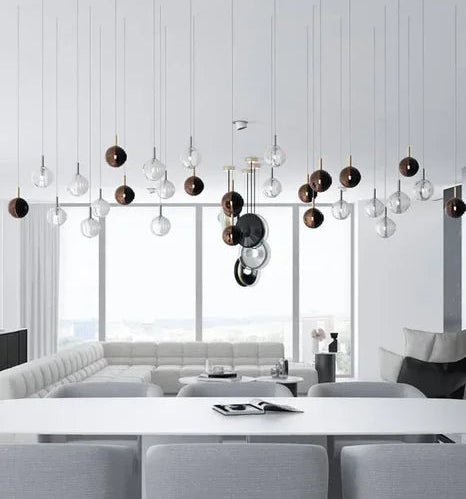 Modern interior with a chandelier, white walls, and a large window.