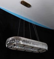 Modern chandelier hanging from a ceiling with a black background