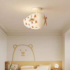 Children's room ceiling light in an airplane design with a fabric shade decorated with teddy bears.
