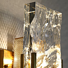 Decorative wall sconce with textured glass panel and metallic accents.