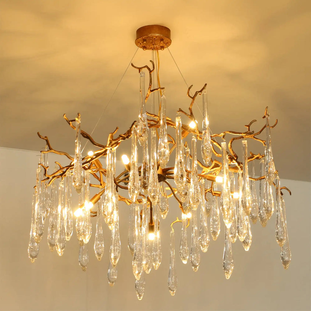 Gold chandelier with crystal-like droplets on a ceiling