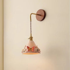 Wall-mounted lamp with decorative shade on a beige wall