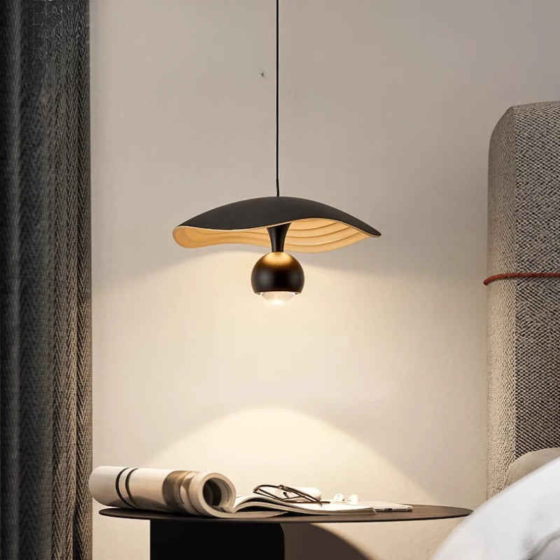 Contemporary aluminum pendant lighting above a stylish restaurant corner