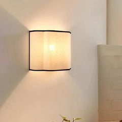 “Minimalist linen drum wall lamp with gentle glow, easy installation”