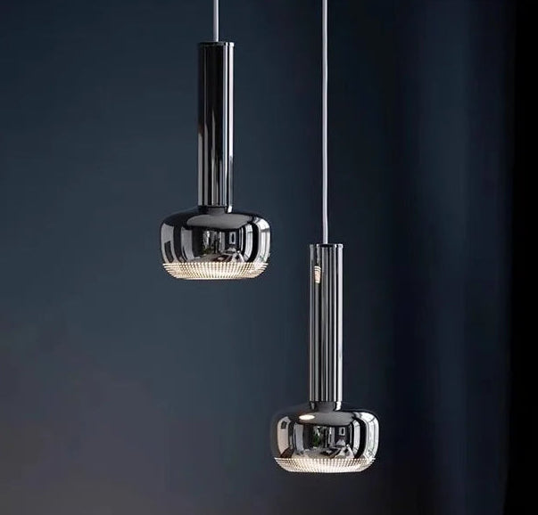 Modern pendant lamp illuminating a bedside table and exhibition backdrop