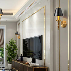 Modern living room with a television mounted on a wall, flanked by decorative lamps and plants.