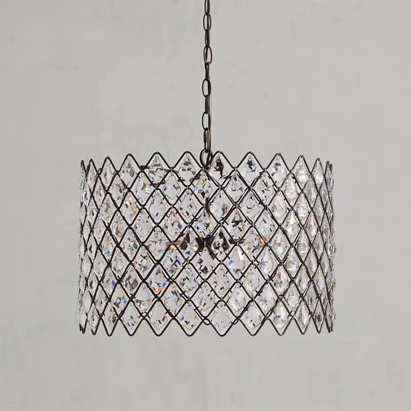 Chain-hung pendant light with faceted crystal for dining spaces