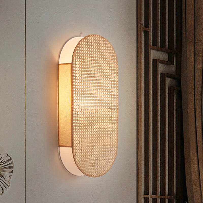 Wall-mounted light fixture with woven design on a neutral wall.