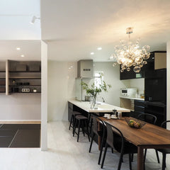 Modern kitchen with a dining area featuring a wooden table and chairs.