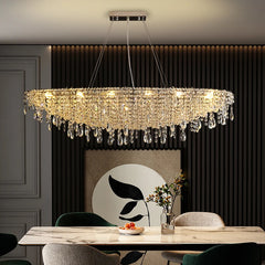 Contemporary crystal pendant chandelier hanging above a luxury dining room