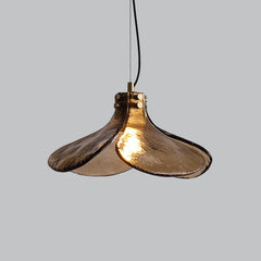 Designer green glass pendant light highlighting the copper body and curved shade.