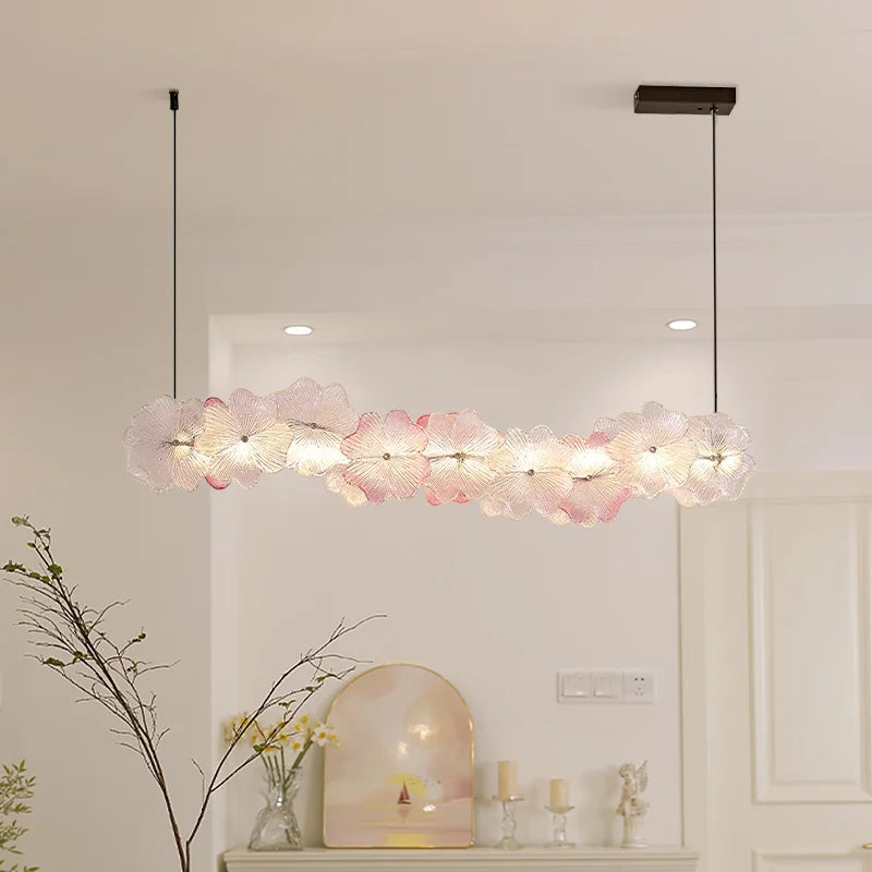 Modern pendant light fixture in a room with decorative elements.