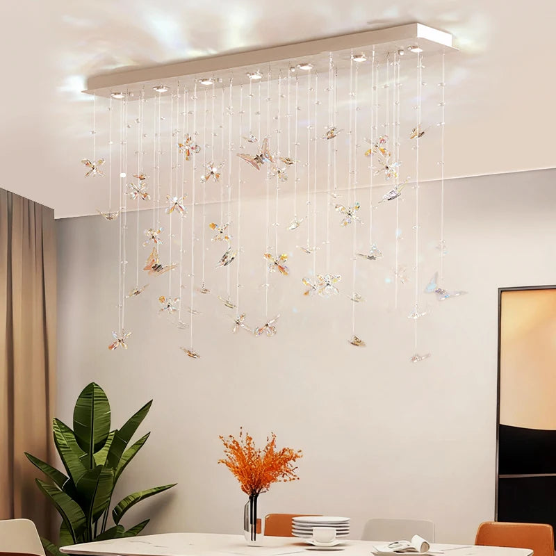 Crystal butterfly pendant chandelier hanging above a dining table setting