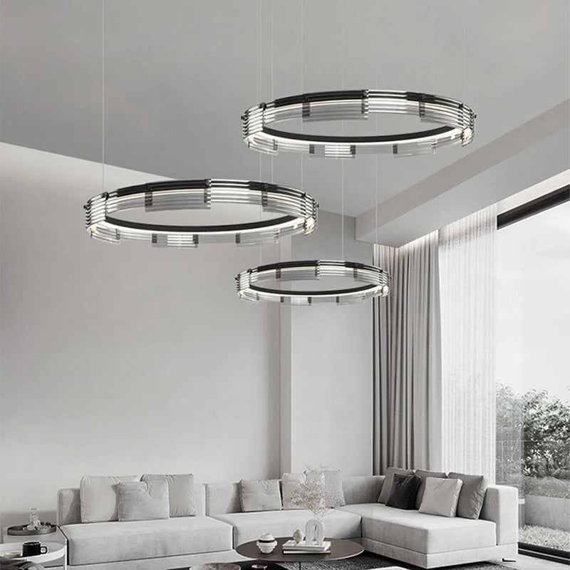 Modern living room with three circular pendant lights hanging above a sofa.