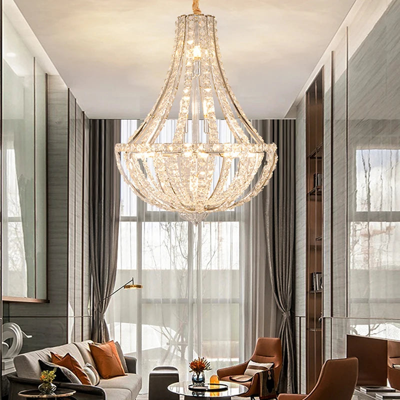 Dimmable LED chandelier suspended from a tall traditional foyer ceiling