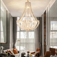 Dimmable LED chandelier suspended from a tall traditional foyer ceiling