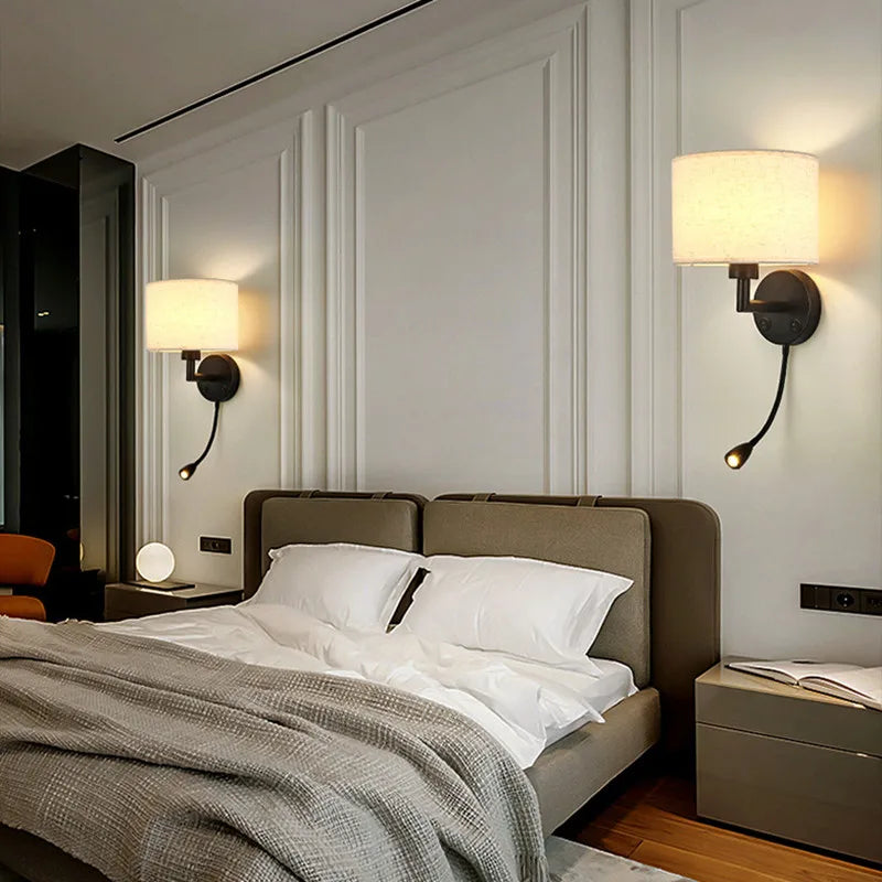 Modern bedroom with a bed, nightstands, and wall lamps.