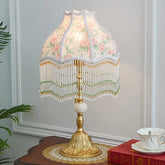 “European retro desk lamp with alloy base and floral fabric tassel shade”