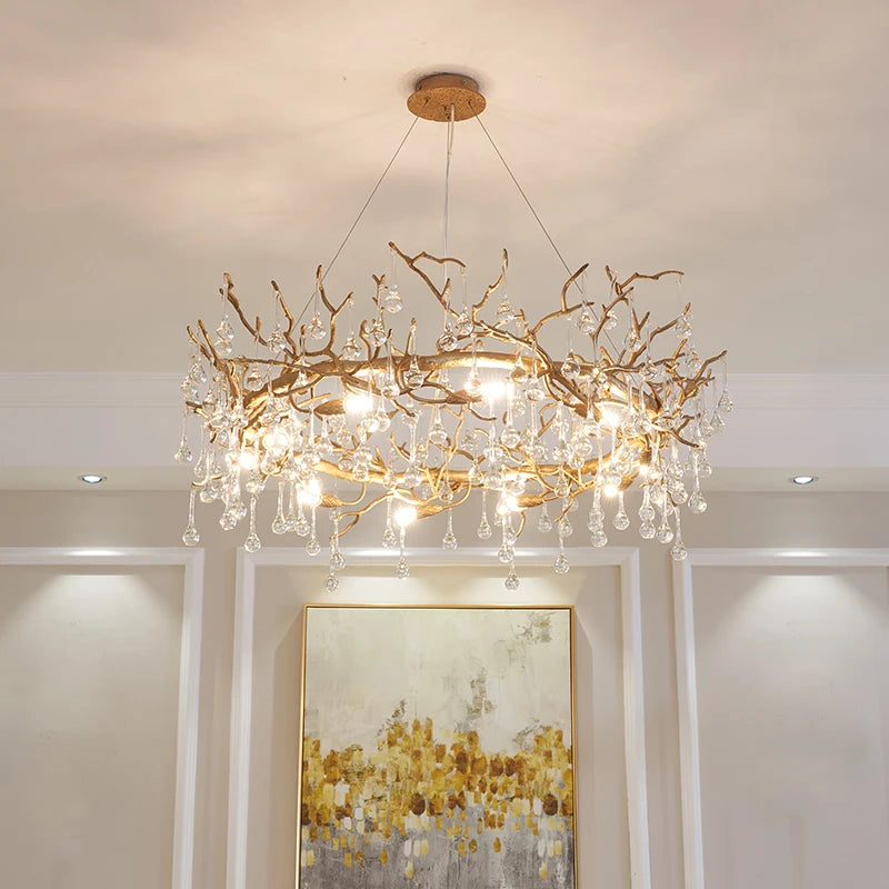 A chandelier with a branch-like design hangs in a room with a painting on the wall. French luxury branch crystal chandelier, modern copper, LED, 3-year warranty.