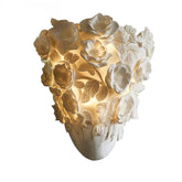 Decorative wall light with floral design on a white background, featuring the brand 'No.7 Lighting'.