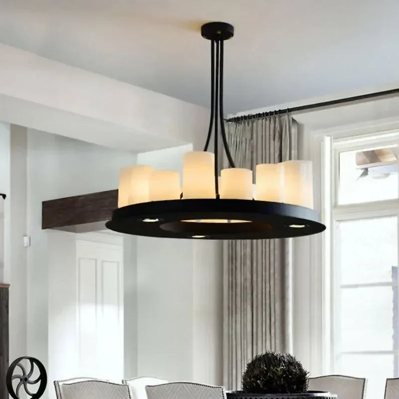 Frosted glass candle-style LED chandelier for classic decorin a room with white walls and a window.