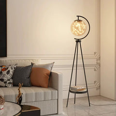 Floor lamp with a round glass shade in a living room setting. Luxury gold storage stand lamp for stylish living and reading spaces.