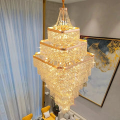 Luxurious gold chandelier in a room with a mirror and yellow chair.