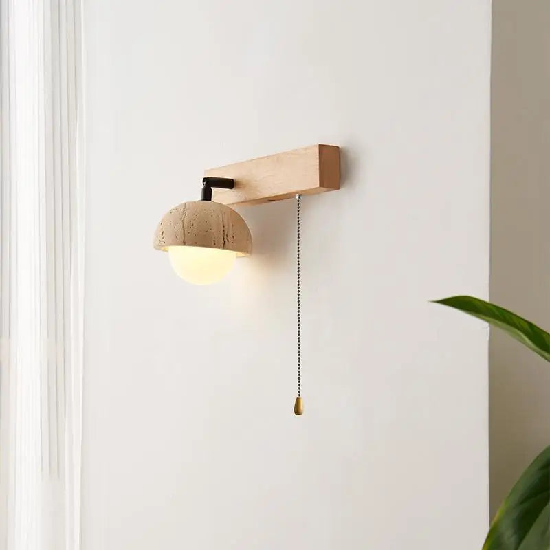 “Modern organic travertine wall lamp used in a hotel-style bedroom setting.”