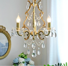 Close-up of polished copper chandelier with hanging crystals