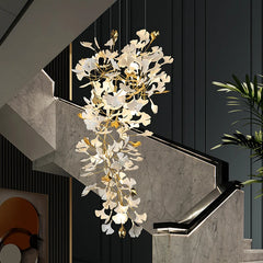 Decorative chandelier hanging above a staircase with marble steps and black walls.