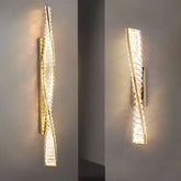 Modern wall sconce with a textured design on a gray wall.