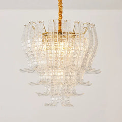 Chandelier with clear glass and gold accents on a white background