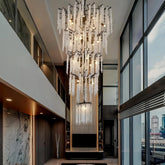Large crystal chandelier hanging in a modern double-height interior