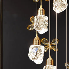 Decorative pendant lights with crystal-like glass and gold accents on a black background