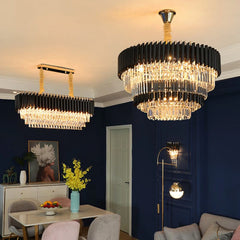 Modern chandelier in a living room with dark blue walls and a table with flowers.