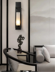 Modern interior design with wall sconce, sculpture, and sofa.