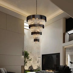 Large crystal chandelier with chain pendant installed over a grand staircase