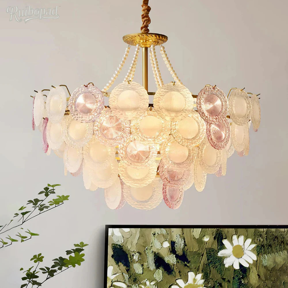 Decorative chandelier with pink and white glass shades on a neutral background