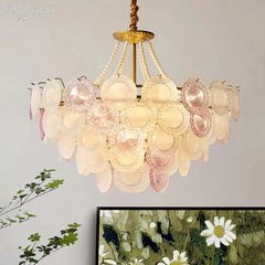 Decorative chandelier with pink and white glass shades on a neutral background
