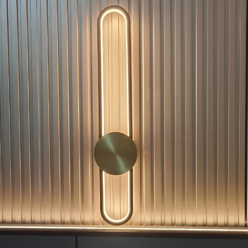 Modern wall light fixture with a circular design on a textured wall.