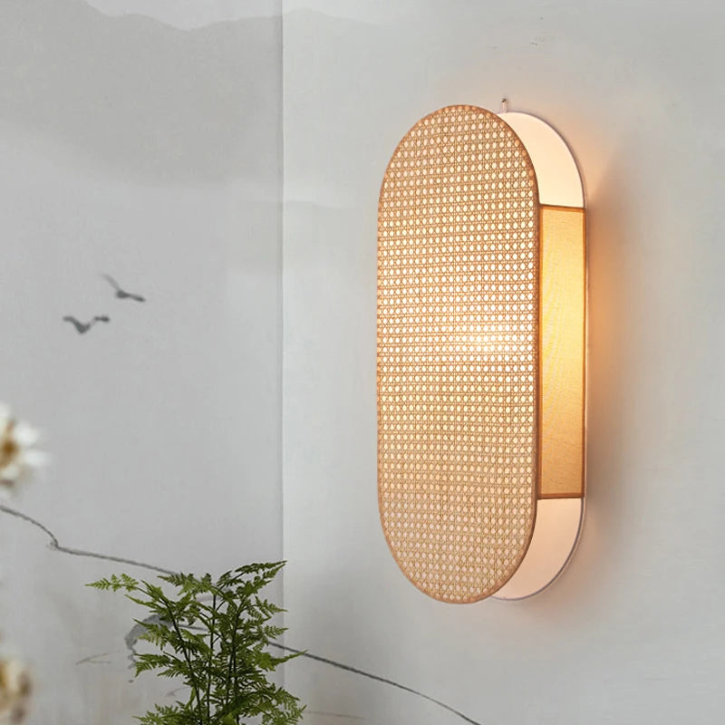 Wall-mounted light fixture with woven design on a neutral wall.