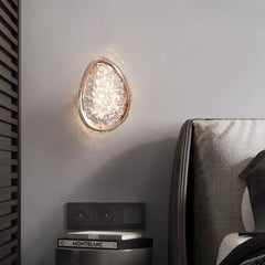 Decorative wall light fixture on a wall next to a Montblanc product.