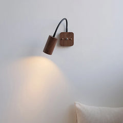 Wooden wall lamp with a light on a white wall