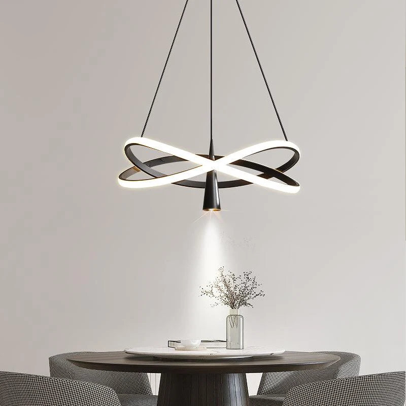 Modern LED pendant light with spotlight effect hanging over a dining table