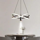 Modern LED pendant light with spotlight effect hanging over a dining table