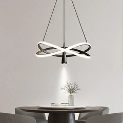 Modern LED pendant light with spotlight effect hanging over a dining table