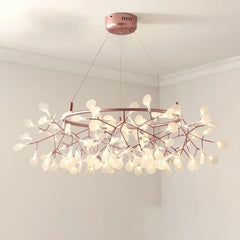 Chandelier with pink branches and white lights on a white ceiling