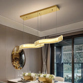 Modern alloy LED pendant chandelier lighting up an elegant dining room