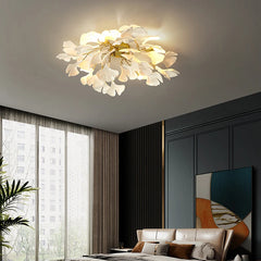 Modern ceiling light fixture in a stylish room with large windows and decorative wall art.