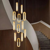 Modern chandelier hanging above a staircase in a stylish interior setting.